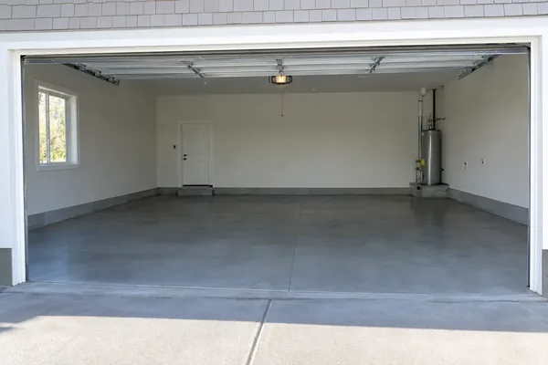 Finished concrete floor in an empty two-car garage