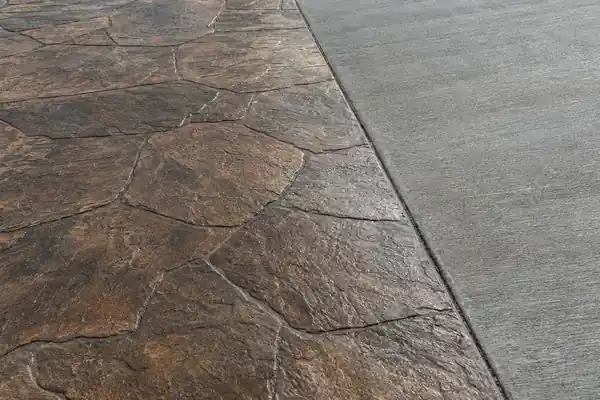 Stamped concrete next to plain broom-finished concrete